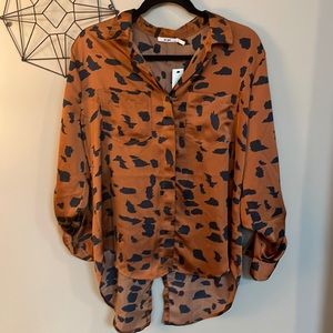 Francesca’s. Printed Blouse with tuxedo tail. Size L.